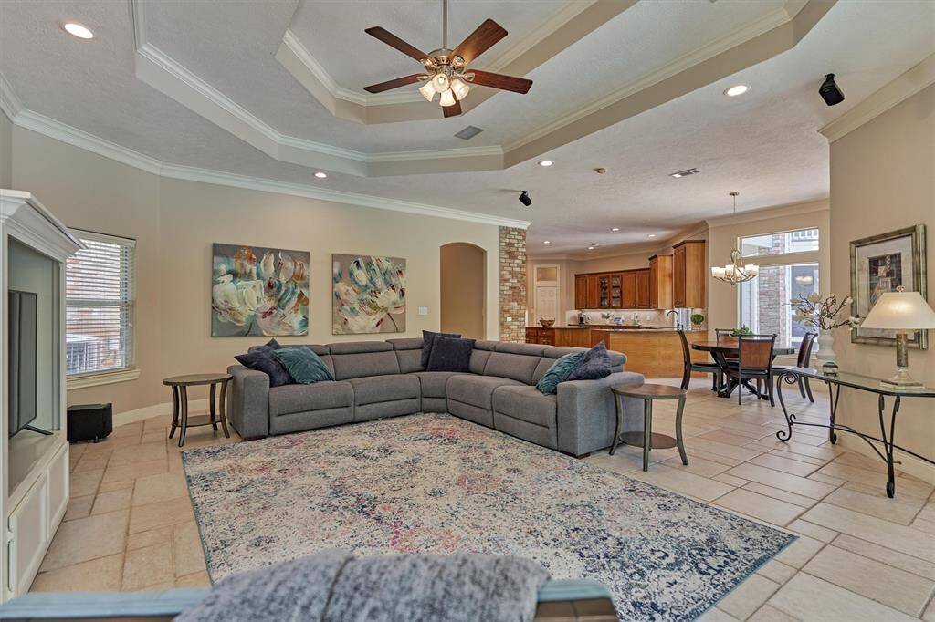 Den with trayed ceiling opens up to the adjoining breakfast room and kitchen.