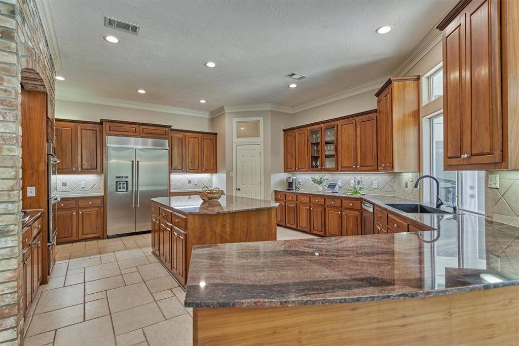 Talk about a chef's dream kitchen with built-in refrigerator, new double ovens, an abundance of custom cabinetry and so much more!