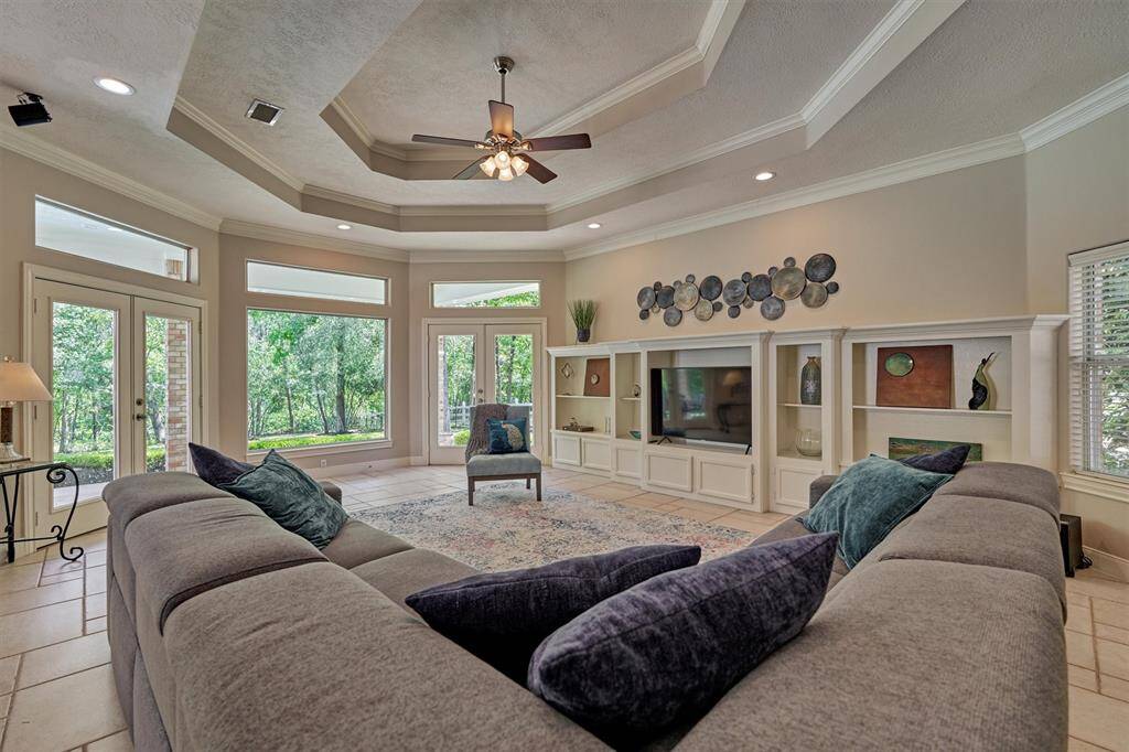 Spacious den has a wall of built-ins and sweeping views of the backyard!