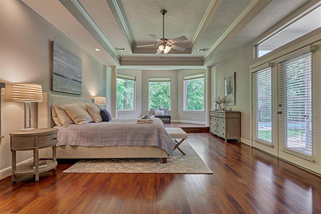 This secluded owner's retreat is what dreams are made of with a trayed ceiling, step-up sitting area, and double doors out to back patio!