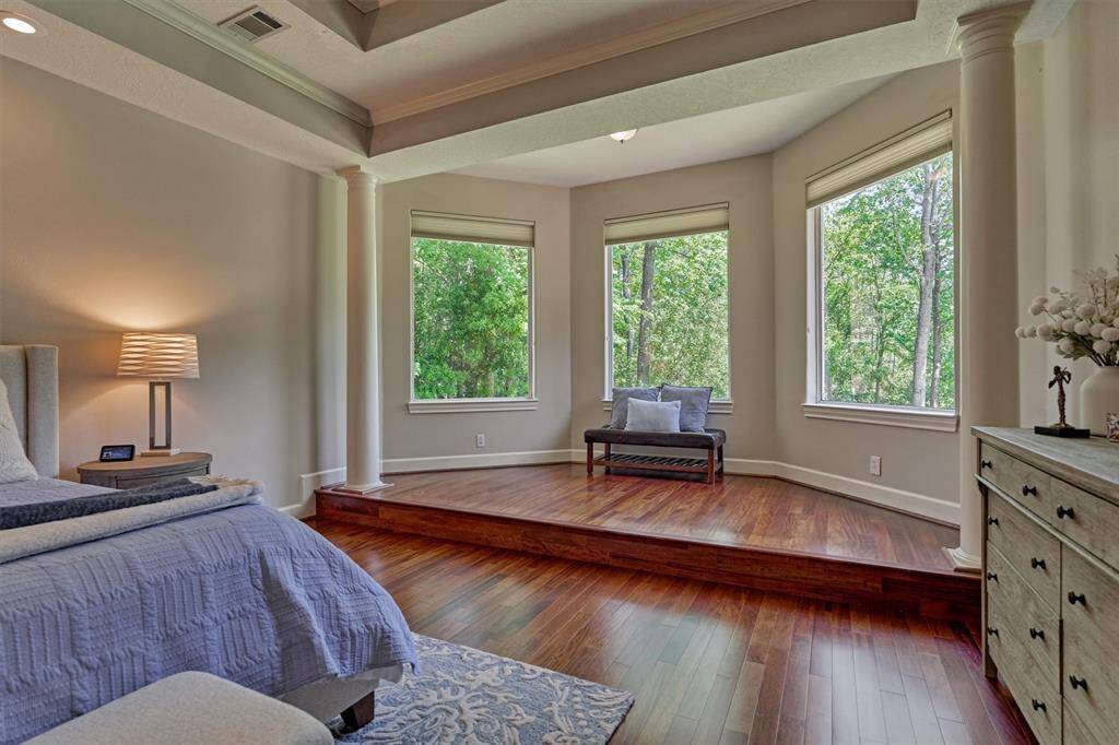 The sitting area has an amazing bay window view of the backyard oasis and water view!