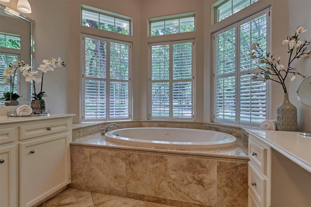 Rest and relax in this spa-like bath tub with beautiful tile surround and plantation shutters!