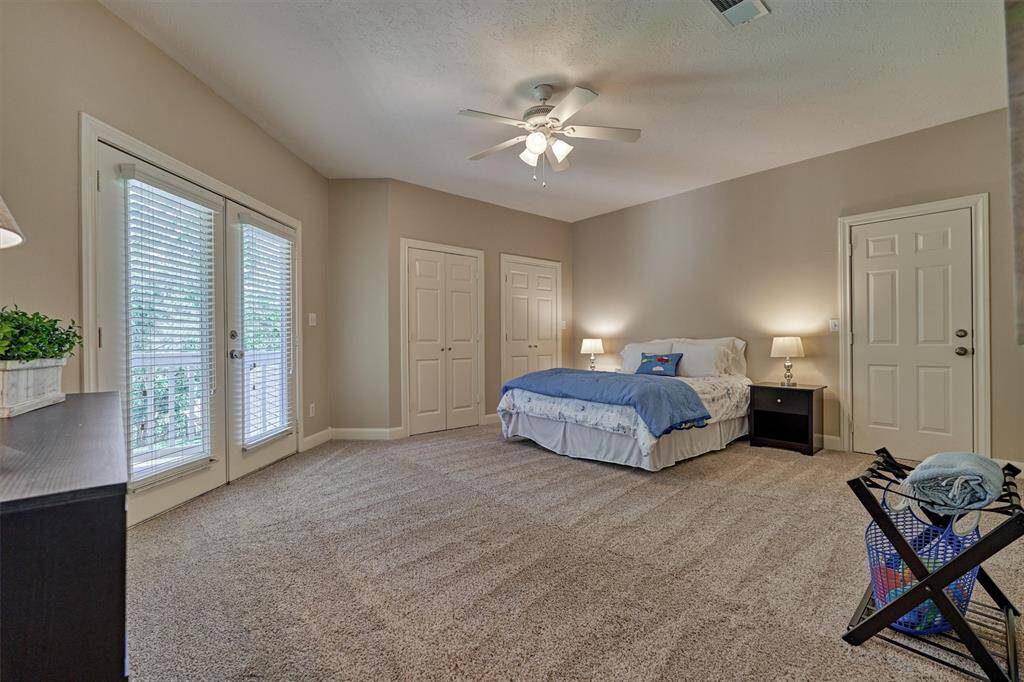 This huge guest suite is like another primary bedroom! Your guests will love the space, privacy, and outdoor balcony!