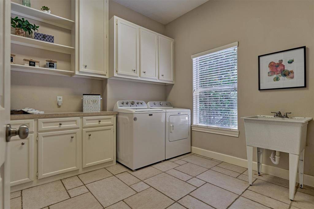 Utility room with sink and tons of storage space!