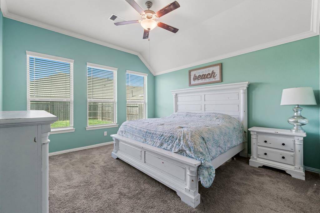 Primary bedroom with ceiling fan 2 inch faux blinds and great windows