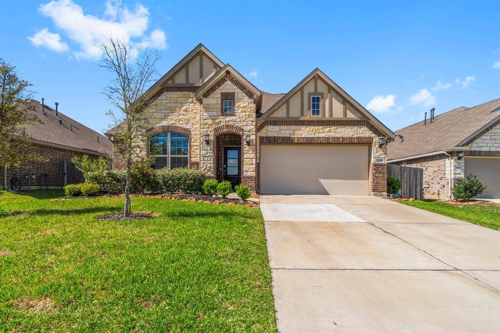 Stone brick elevation with double wide driveway for extra parking.