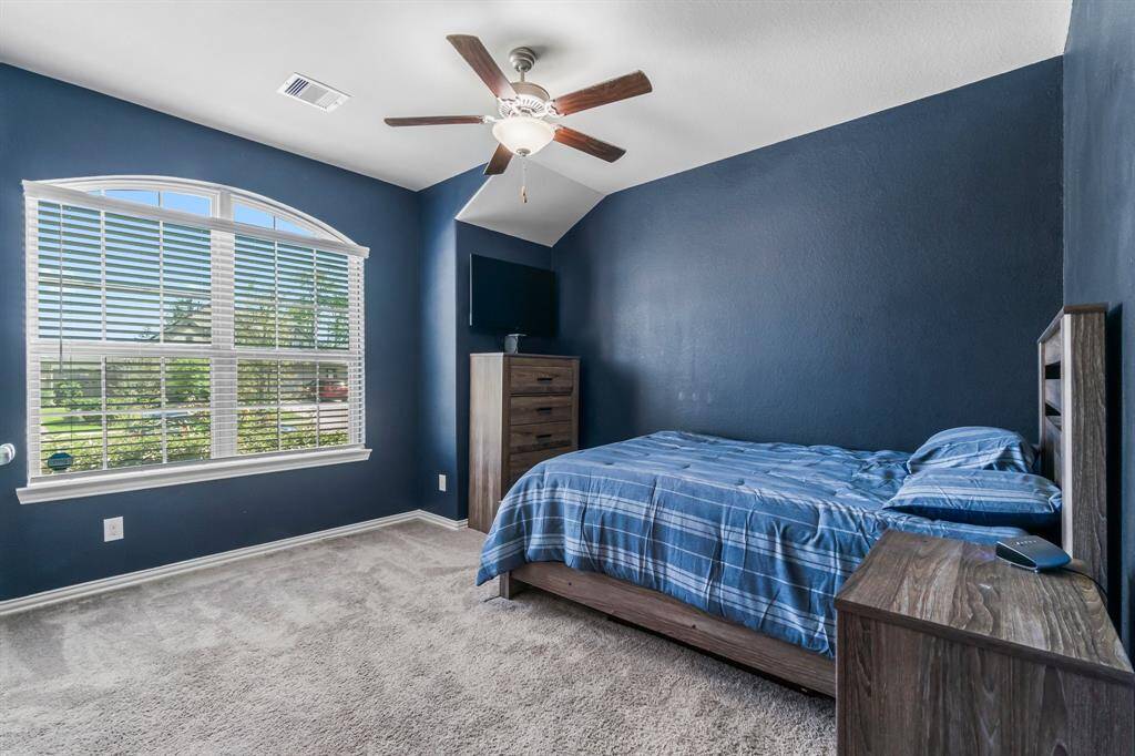 Large secondary bedroom with ceiling fan, 2 inch faux blinds, and great window