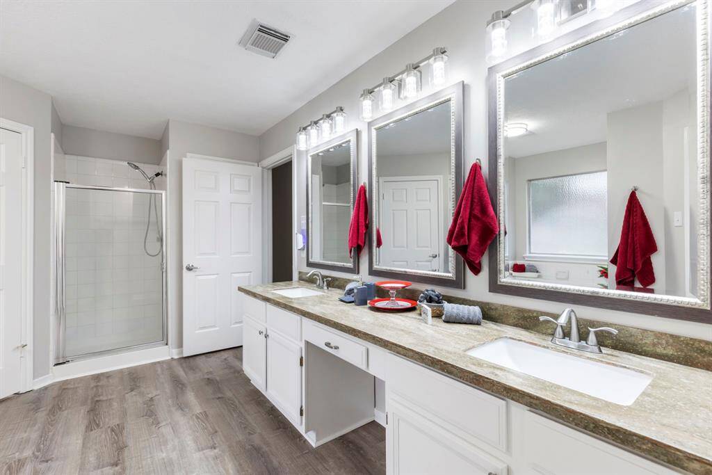 Admire the freshly painted cabinets, stylish new framed mirrors, separate shower, double sinks, and updated fixtures with customizable LED lighting that allows you to choose between cool or warm tones.