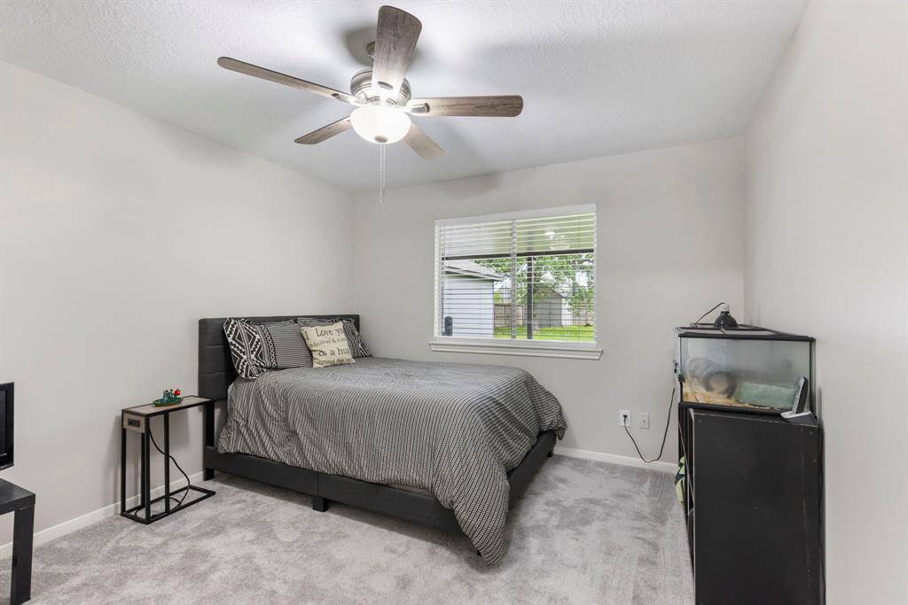 Enjoy peaceful backyard views from this well-appointed secondary bedroom.