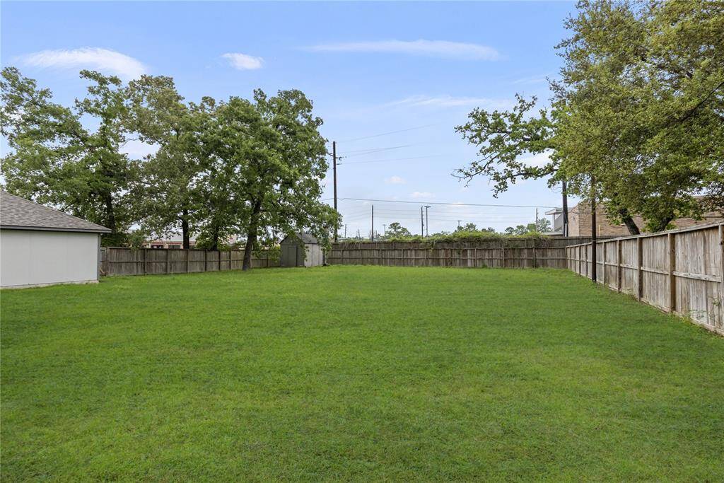 The spacious backyard offers endless potential for creating your dream tropical oasis, with plenty of room for a pool.