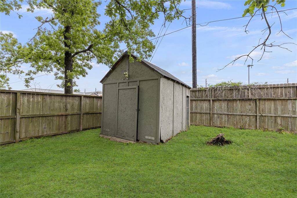 A convenient shed is already in place, ideal for storing lawn equipment and tools.