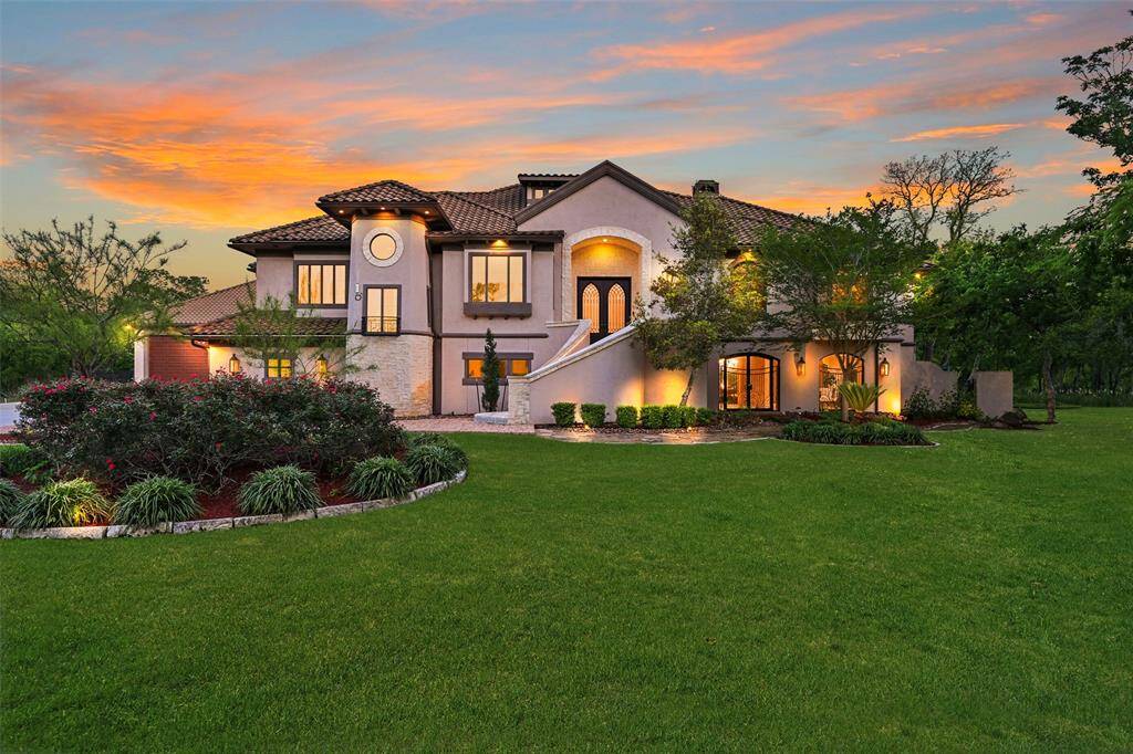 Impressive concrete & stone exterior with concrete tile roof, manicured 3.788 acres, extensive outdoor lighting & waterfront to Chigger creek.