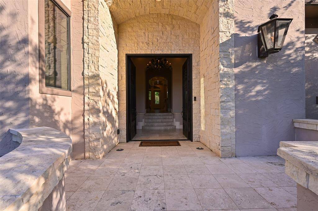 Throughout the home's interior and exterior, Jerusalem Fossil Limestone flooring is featured. Exterior gas carriage lanterns are generously situated around the home's exterior providing beauty both day & night.