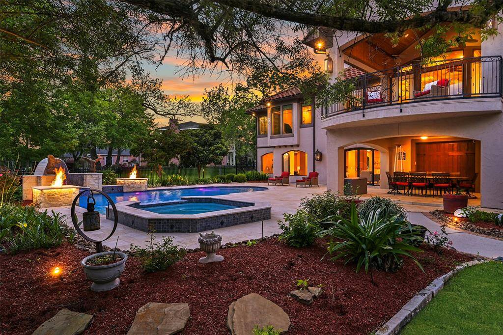 Tranquil gardens, sweeping trees, outdoor sprinkler system and extensive outdoor lighting, professionally designed and installed by Texas Outdoor Lighting, highlight the beauty of the outdoor living & entertaining that this home provides.
