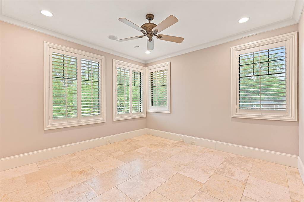 The 3rd secondary ensuite features a beautiful display of windows that offers incredible views of the back lawn and neighboring acreage property.