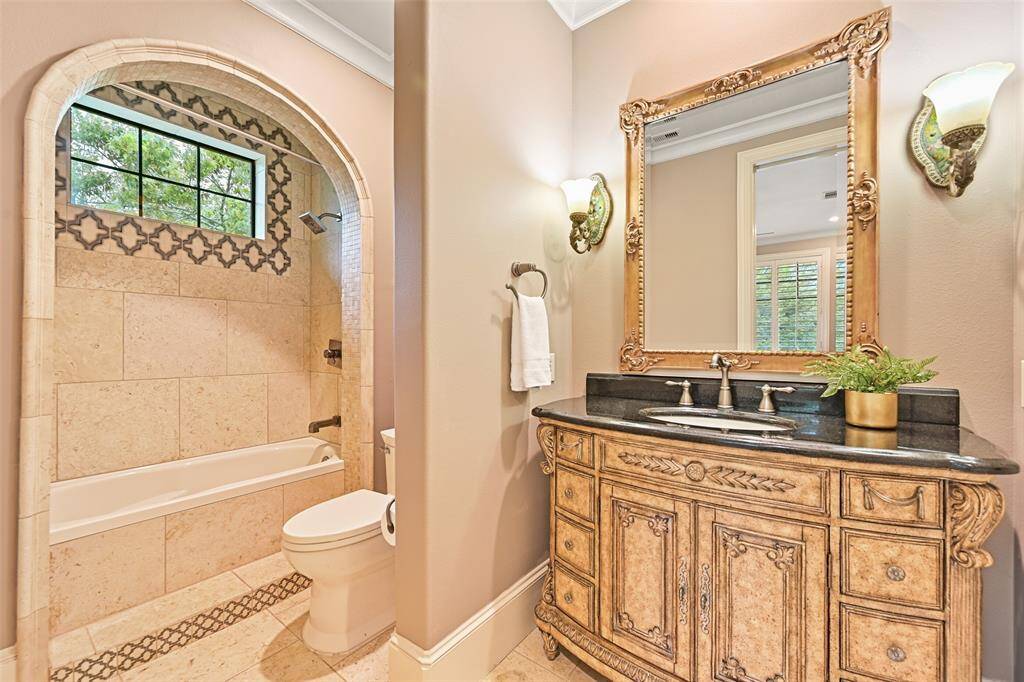 The attention to detail and selection of finishes is unmatched in this grand home. The Antique European inspired vanity compliments the details of the stone and tile beautifully.