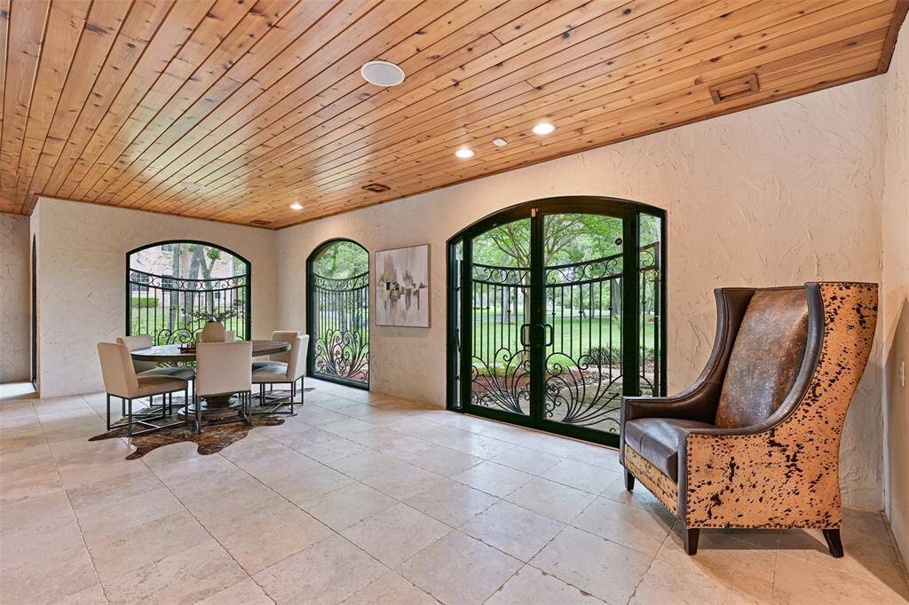 Beautiful wood ceilings, continuous limestone floors, double glass doors with intricate iron work to accessorize the uniqueness and appeal to this grand entertaining space.
