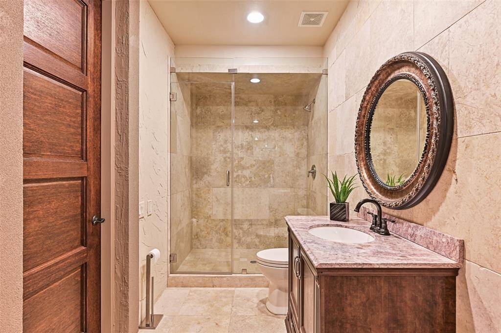 A spa-like full bathroom is located downstairs with easy accessibility to the pool area, game room and exercise room.