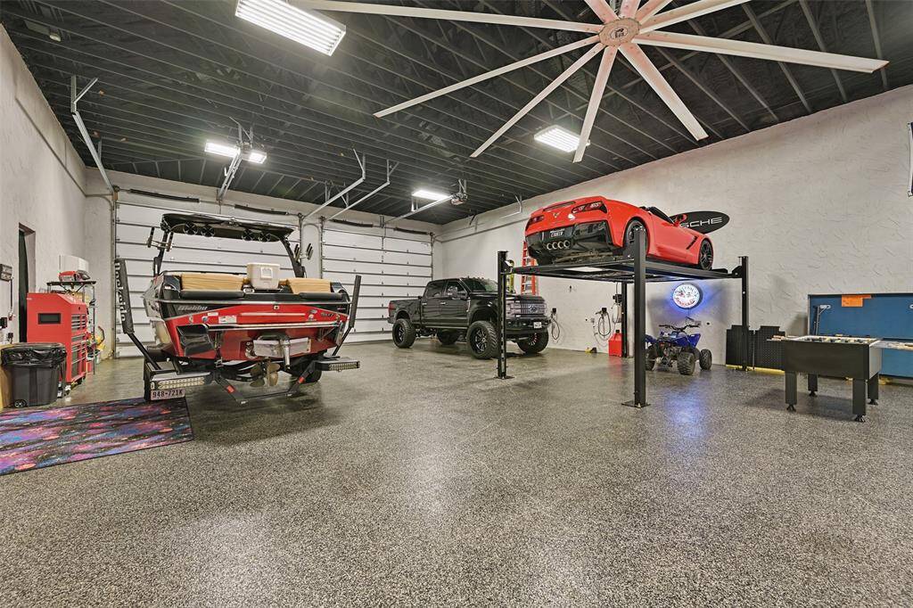 The auxiliary building showcases epoxy floors, industrial/commerical fan system, 2 wall AC systems, security system linked to main home's system, large overhead door (2 at front & 1 at rear) & electronic single car lift with bright & luminous LED lighting above.