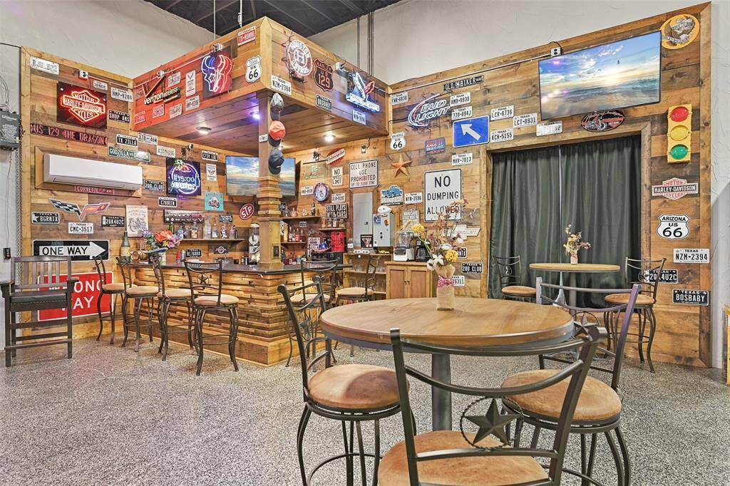 A closer look at the lively & rustic bar area. Lighting, media and sound systems enhance this space to an unmatched spot for a hangout to enjoy viewing sporting events and more.