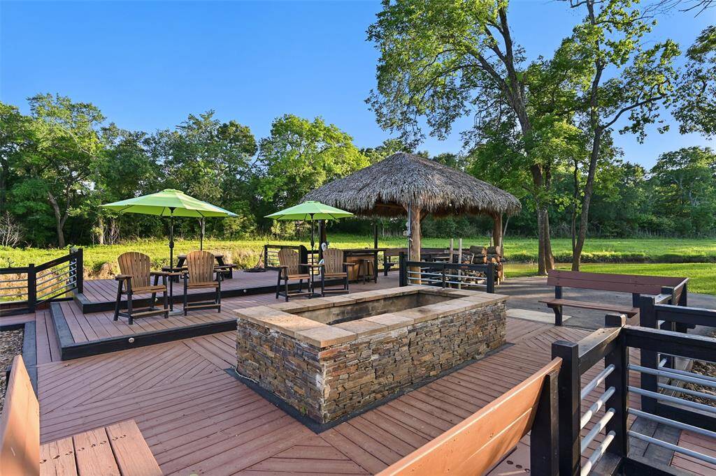 A huge stone fire pit is a central focal and conversation area to hang out by the water & palapa. Built-in deck seating and chairs offers multiple areas to sit by the fire.