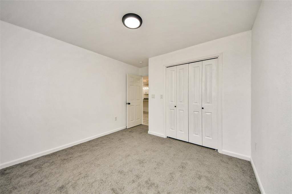 Spacious closet and open layout in the second secondary bedroom, continuing the home’s cohesive design.