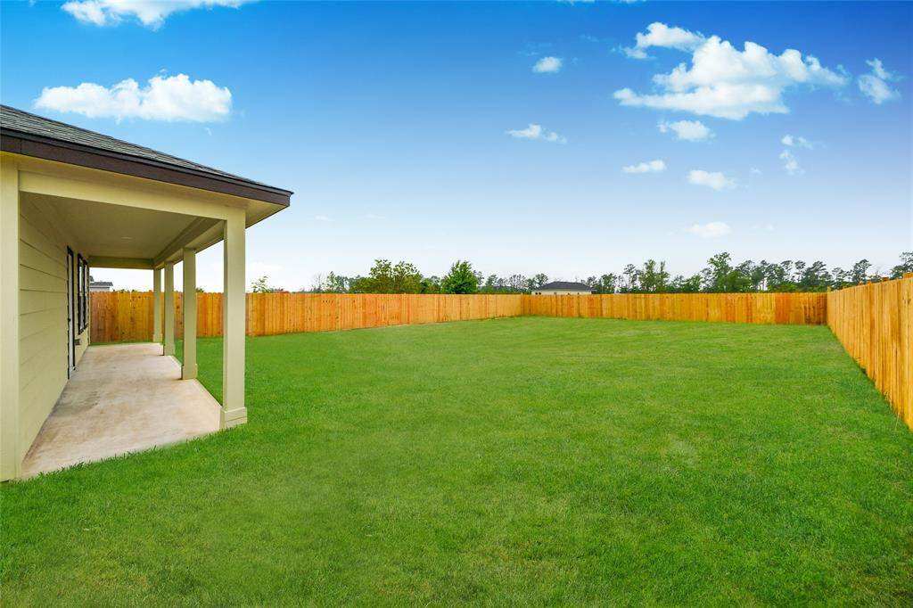 A covered patio area just off the back door — ideal for enjoying morning coffee or evening sunsets.