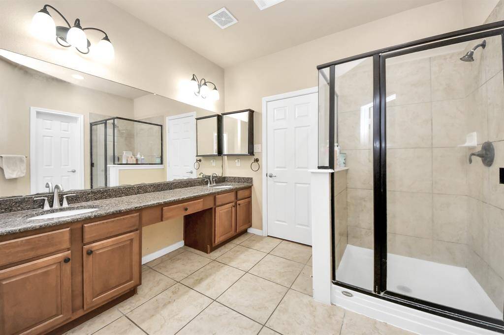 Primary bathroom has the dual sinks, Jacuzzi tub and spacious stand alone shower.