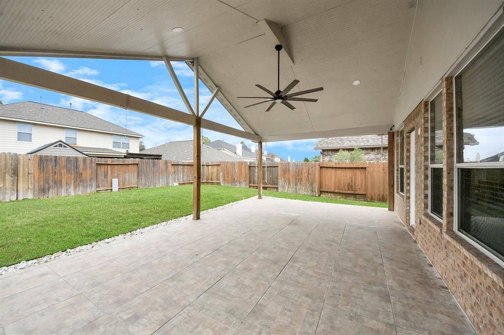 Huge back patio for family and friends to hang out as well as grill under the covered patio.