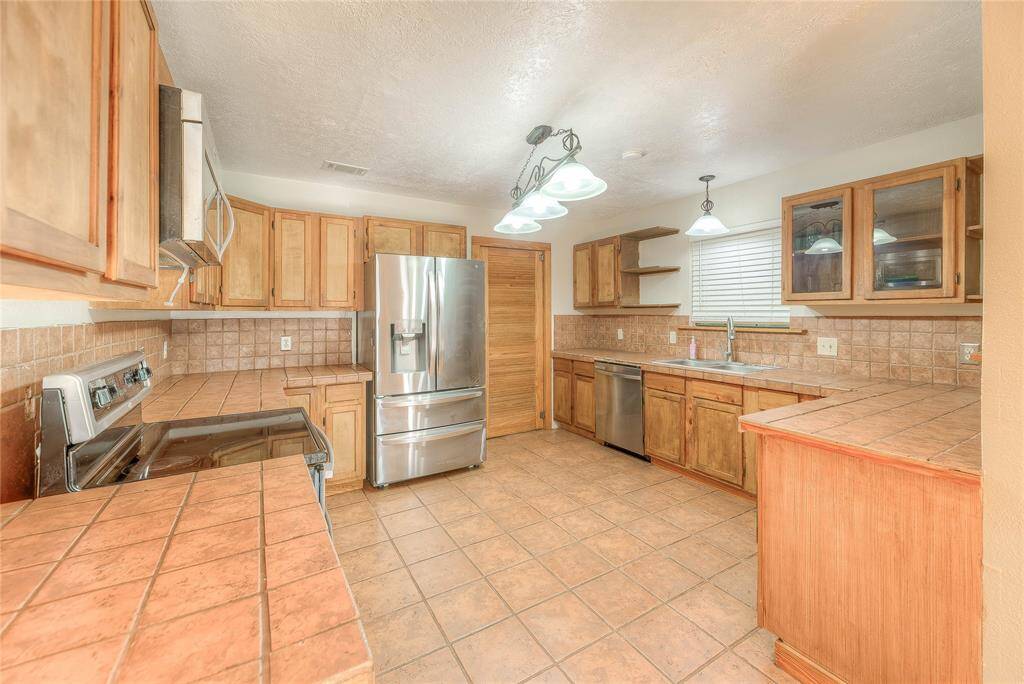 Beautiful newer Stainless steel appliances with custom wood cabinets.