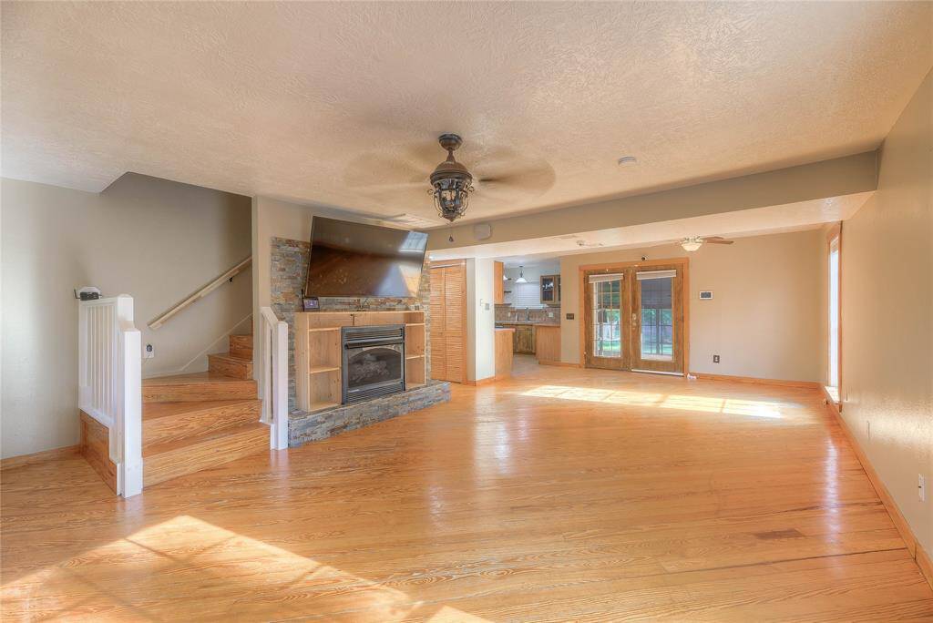 Gas fireplace in living room with stairs leading to 2 bedrooms up & bathroom.