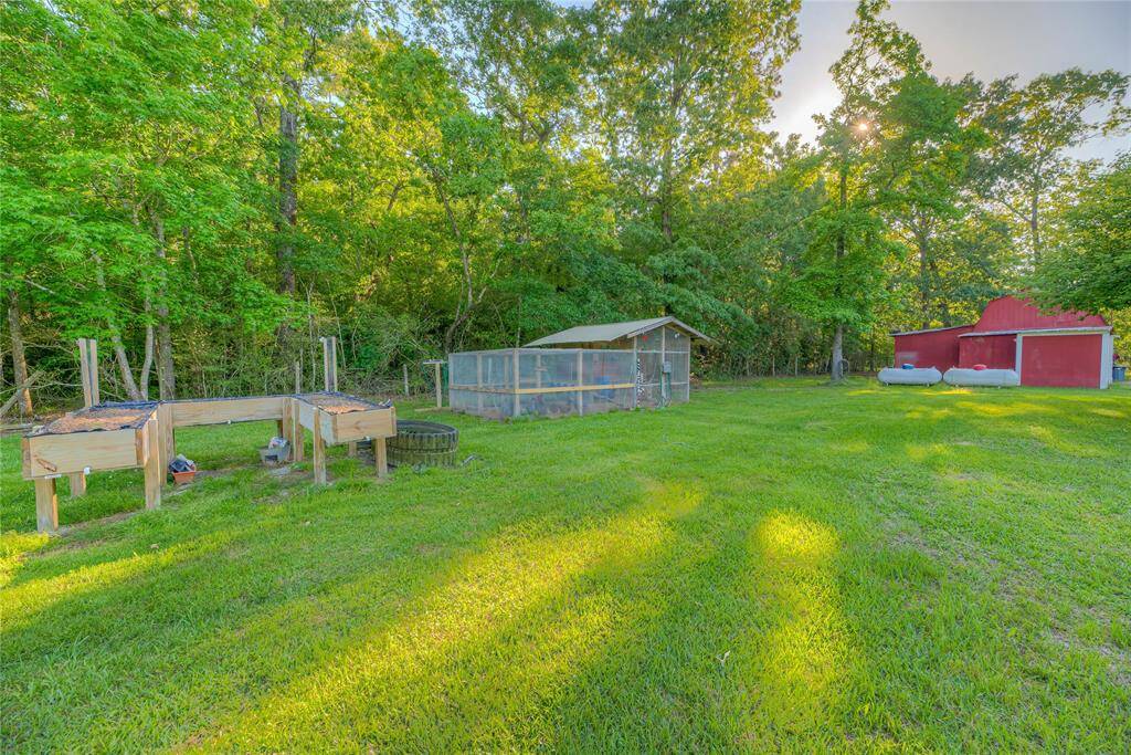 Chicken coop with automatic waterer & raised garden beds.