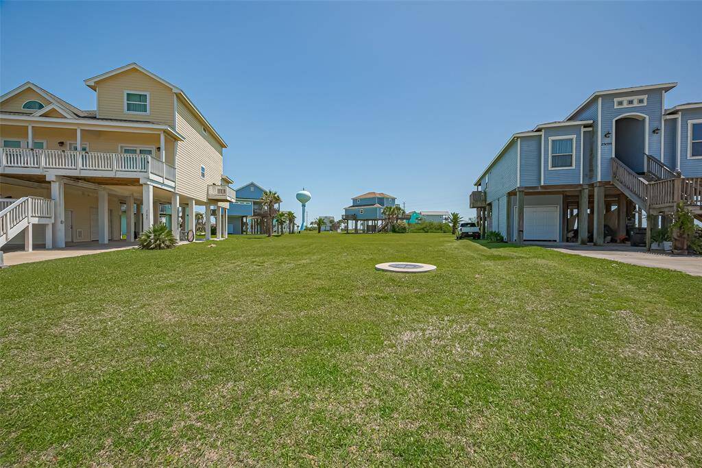 This view emphasizes the full breadth of the lot, where a seamless carpet of grass stretches across the entire space, hinting at future potential.