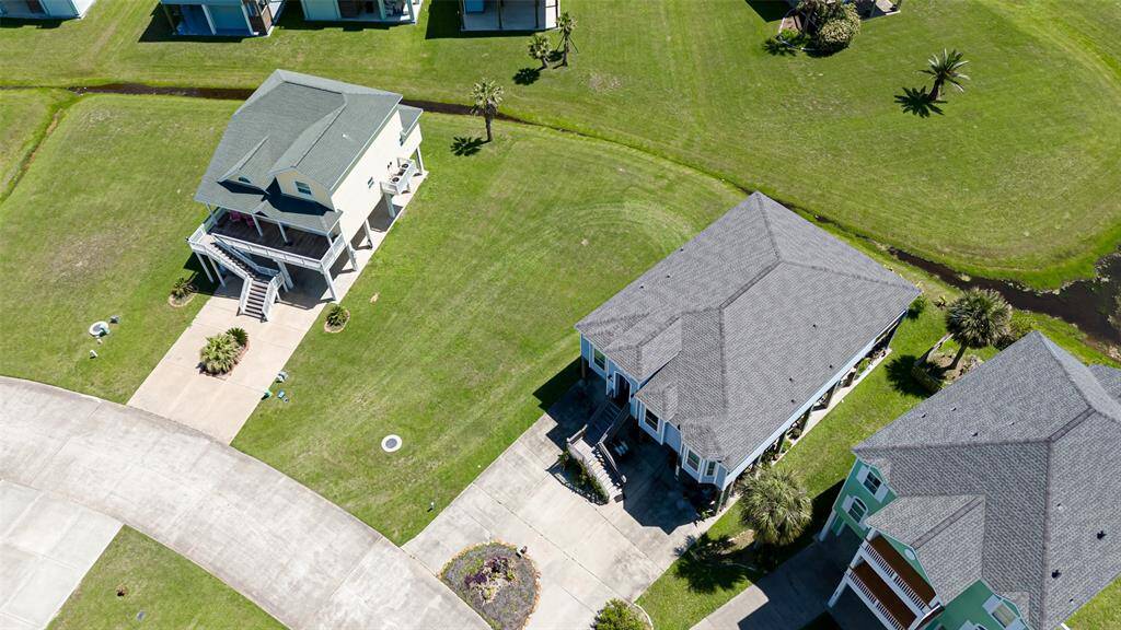 Slightly angled from above, this aerial image highlights the gentle contour of the landscape behind the lot, adding a sense of depth and visual interest.