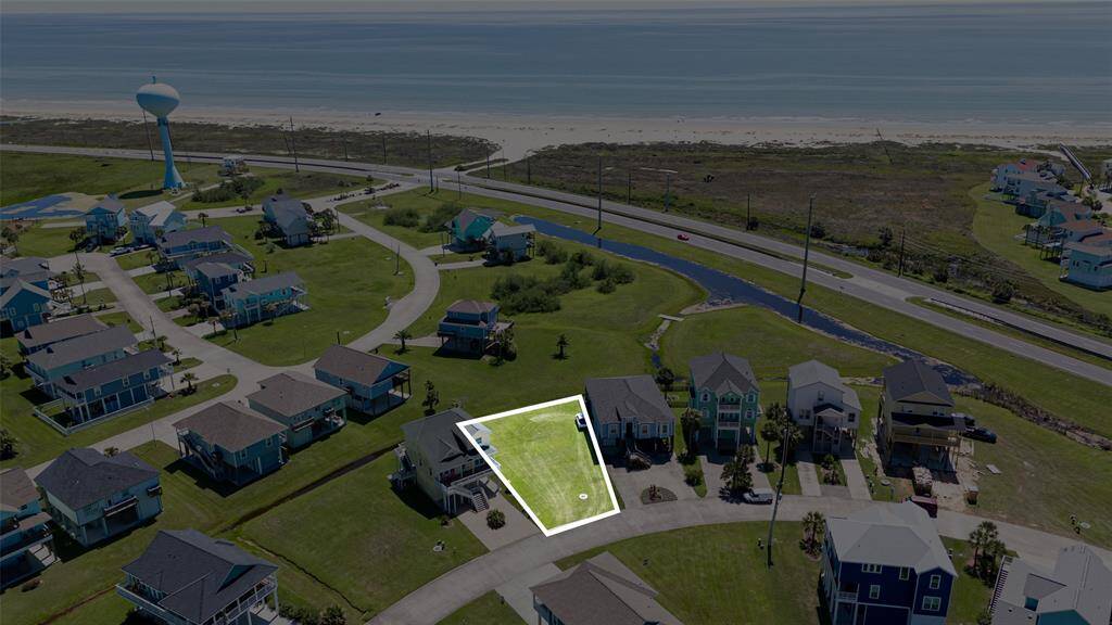 Outlined for clarity, this aerial shot emphasizes how close the property sits to the ocean, with the beach just steps beyond the community’s edge.