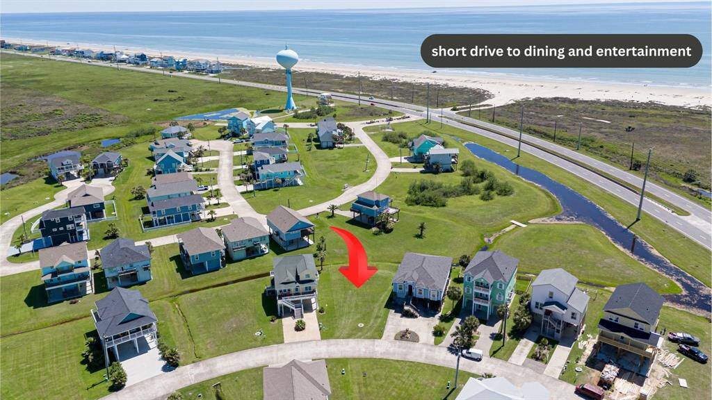 This elevated view captures not only the lot but its proximity to the coast—the beach lies just beyond, a constant presence in everyday life.