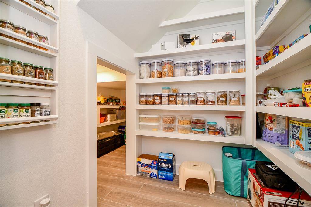 Large spacious pantry with spice rack and lots of stacking space.