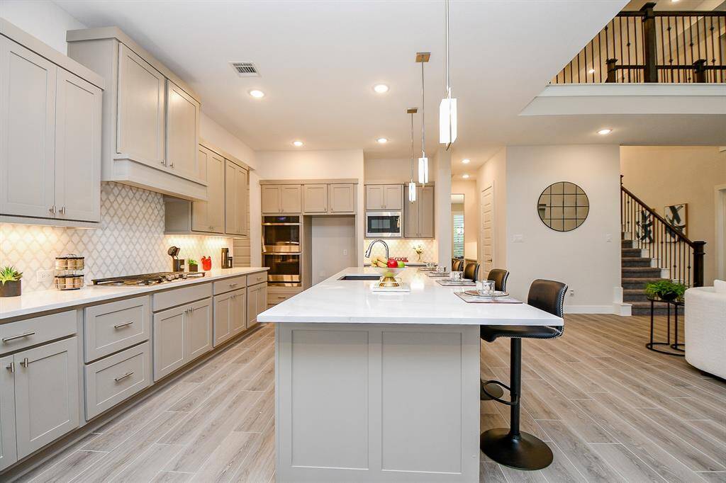 Large gourmet kitchen with a huge island. notice the stunning quartz countertop.