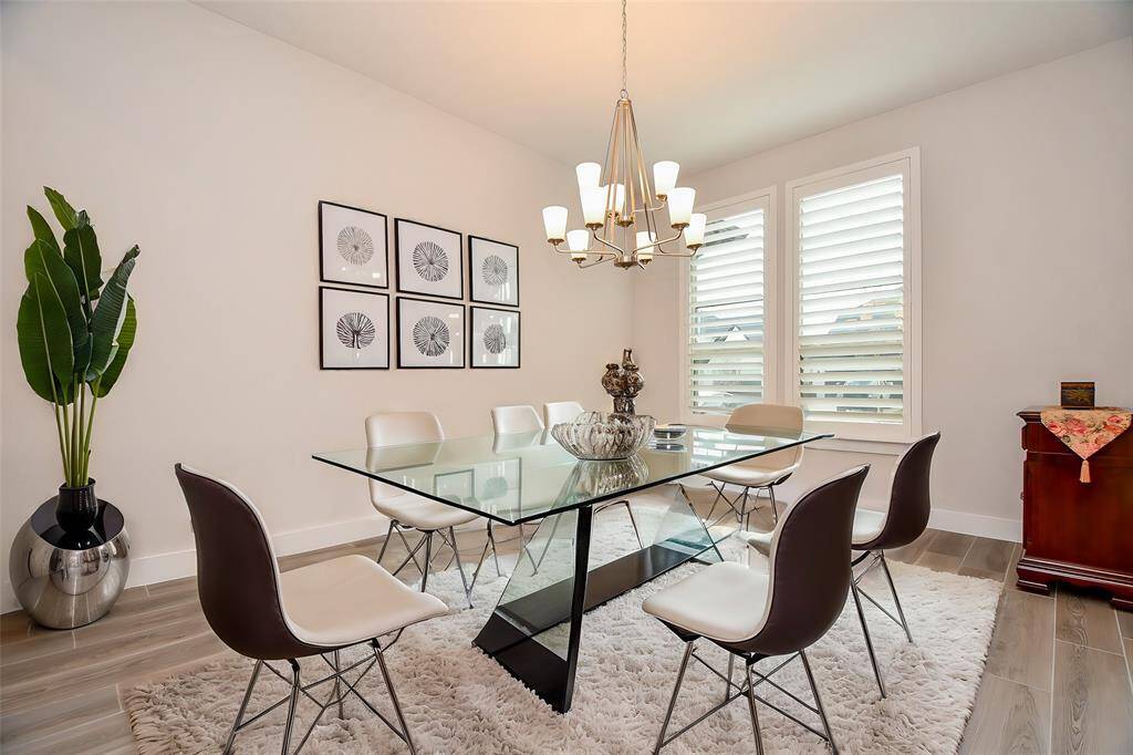 Good sized formal dining room with plantation shutters. Every color including floors, paint are neutral and tastefully done