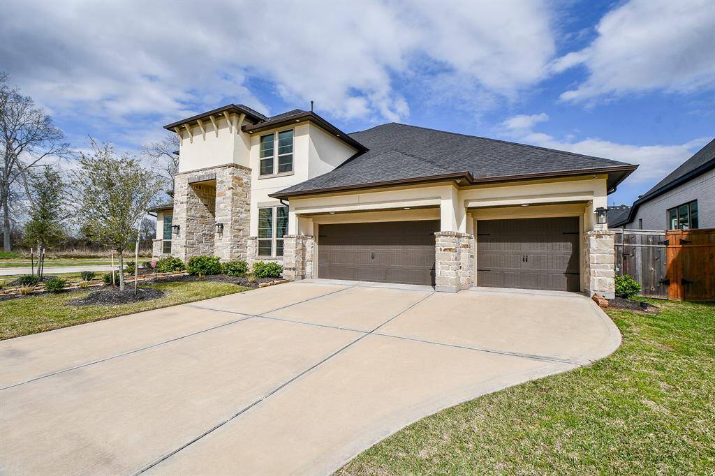 Large driveway with oversized three car garage!