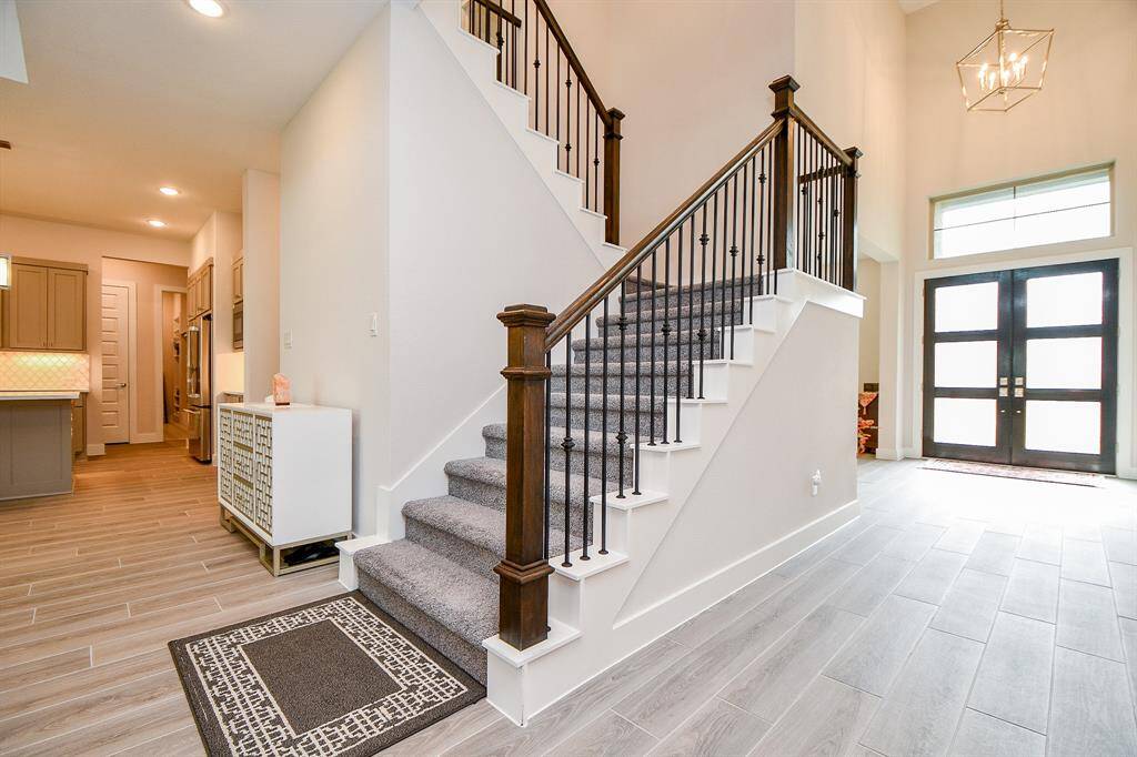 Stair leading with wrought iron railing leading to the second floor