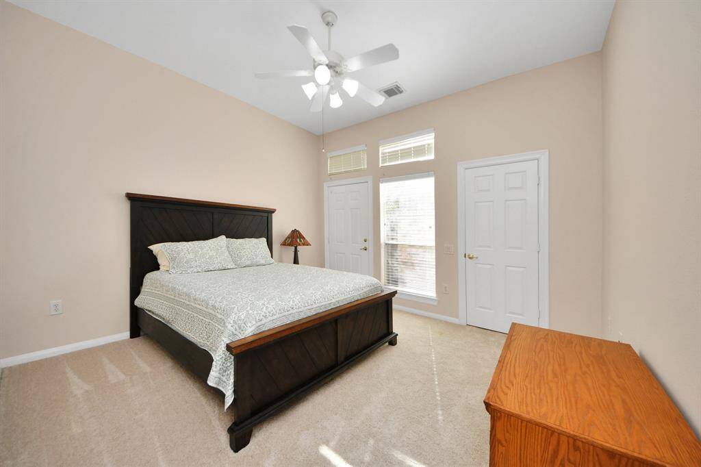 cozy secondary bedroom offers a serene ambiance, complemented by a dedicated nook just outside the room—perfect for enjoying morning coffee or immersing yourself in a good book