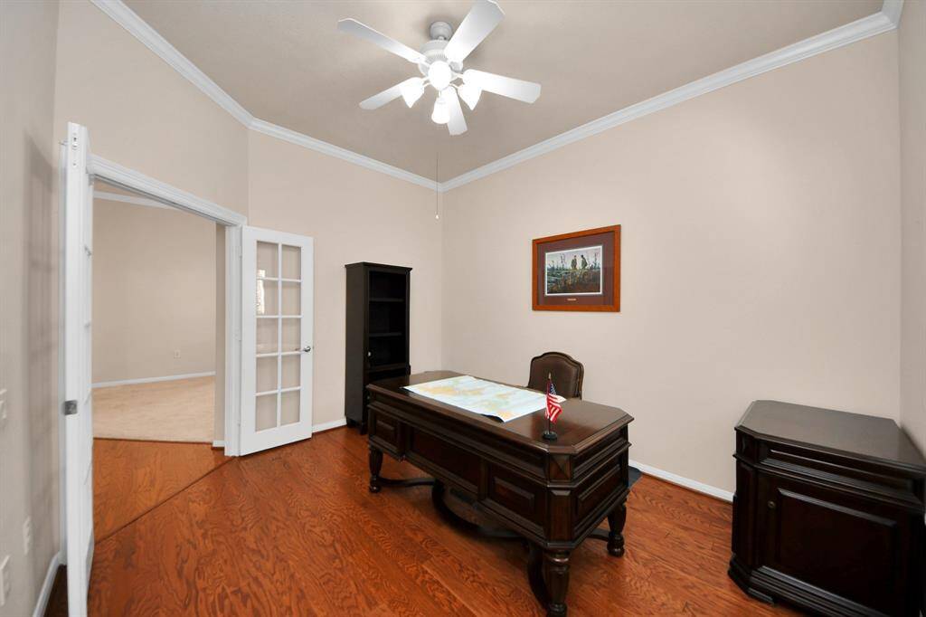 Located just off the foyer, this inviting office features elegant French doors that allow abundant natural light to fill the space, creating a bright and welcoming atmosphere