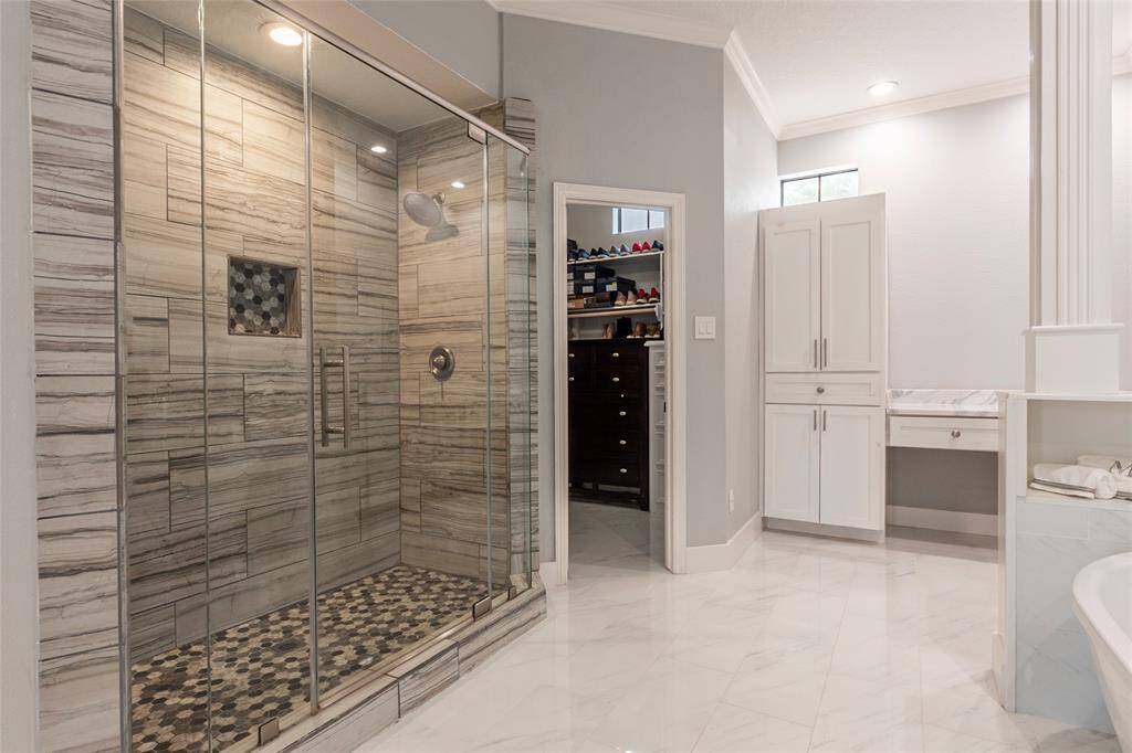 Custom separate shower/soaking tub in the primary bathroom