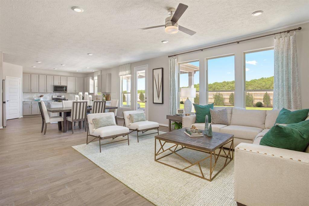 The open concept great room, dining and kitchen makes for a impressive way to keep the party going and never miss a beat! Gather the family together in good conversation while preparing a fabulous meal in the breathtaking kitchen! The Great Room features large windows with window coverings, high ceilings, ceiling fan, recessed lighting, and gorgeous Saffron Wire Brushed White Oak Engineered Wood!