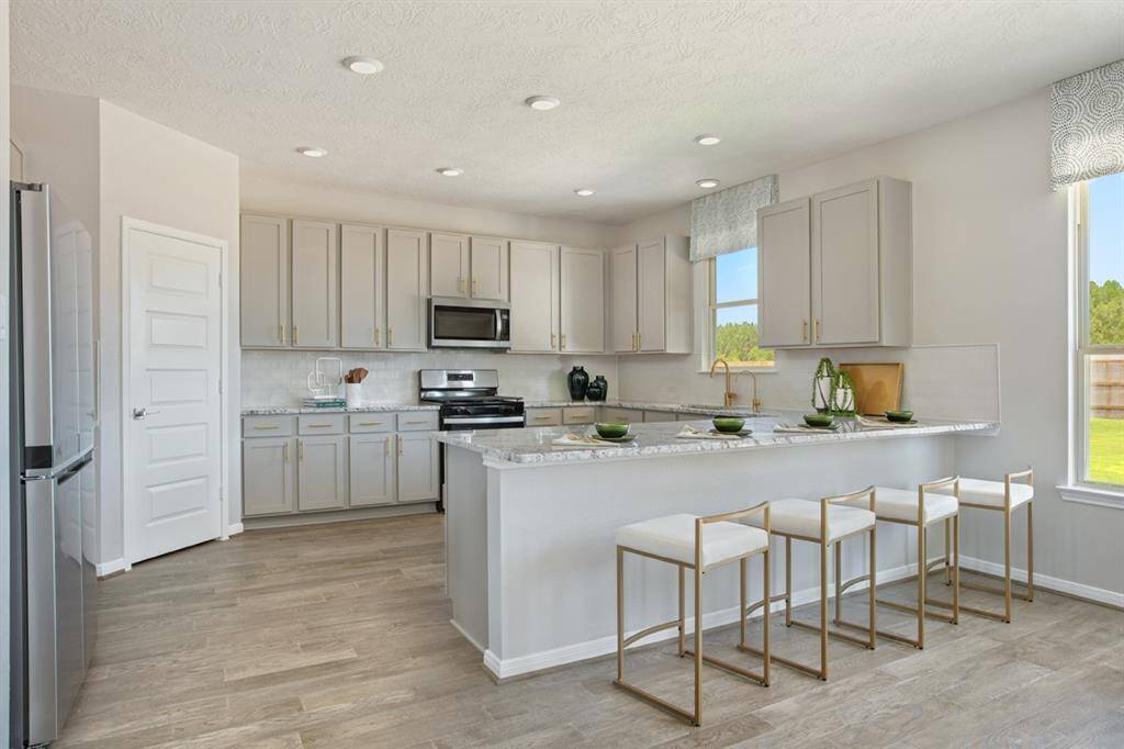 This beautiful kitchen will not disappoint! Your family and guests will enjoy many nights of fun, food and entertainment with ample counter space for setting up a wonderful array of provisions! The kitchen showcases an extended countertop for breakfast bar, high ceiling, recessed lighting, engineered wood flooring, SS appliances, granite countertops, beautiful tile backsplash, pantry, and windows with window coverings!