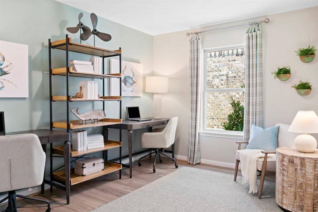Quietly nestled in the home is this gorgeous Den, featured here as a home office! Featuring vinyl plank flooring, high ceilings, large window with window coverings, and custom paint! Window coverings and art work to be sold with home.