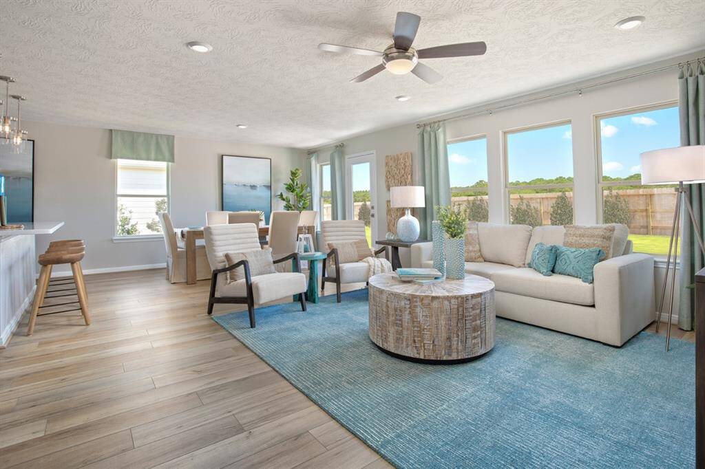 The open concept Great Room, dining and kitchen makes for a impressive way to keep the party going and never miss a beat! Gather the family together in good conversation while preparing a fabulous meal in the breathtaking kitchen! The Great Room features large windows with window coverings, high ceilings, ceiling fan, recessed lighting, and vinyl plank flooring! Window coverings and artwork to be sold with home!