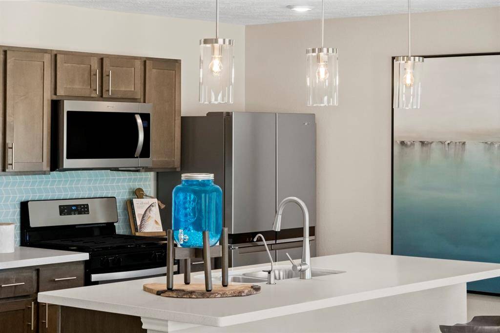 Another view of this spacious kitchen and it's beautiful cabinetry. Stainless steel Whirlpool 4-Door French Door , and pedant lighting!