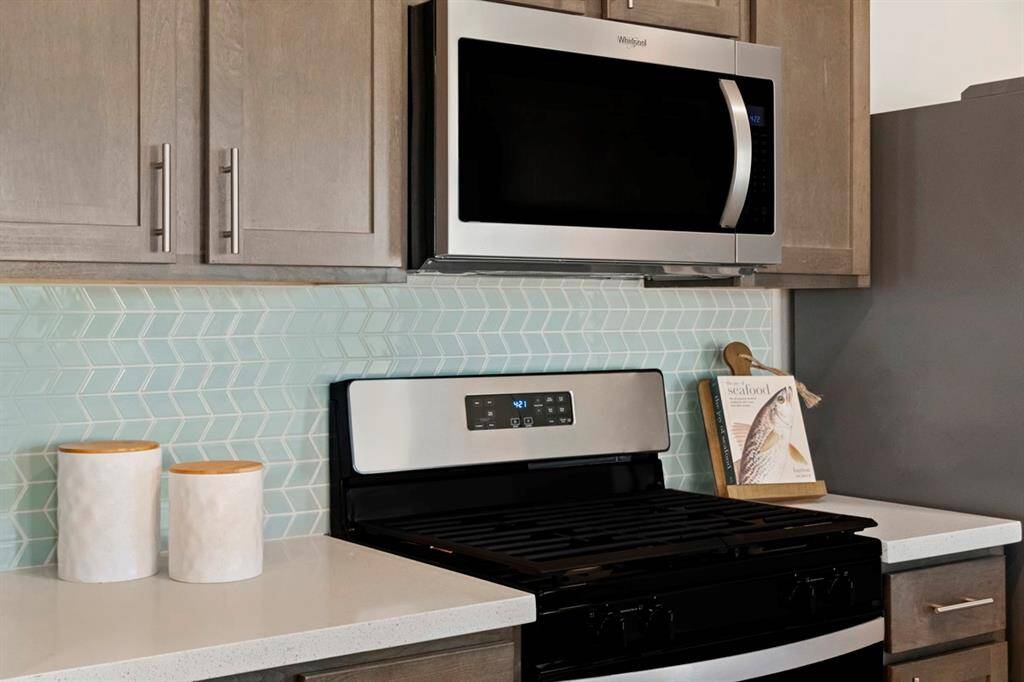 Featured here is the Whirlpool Black on Stainless Freestanding Gas Range, Under-Oven Broiler, SpeedHeat Burner with the Whirlpool Microwave/Hood combo. This gorgeous mosaic tile backsplash will not disappoint.